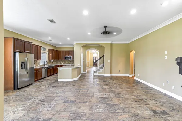 a view of a kitchen with a sink and refrigerator