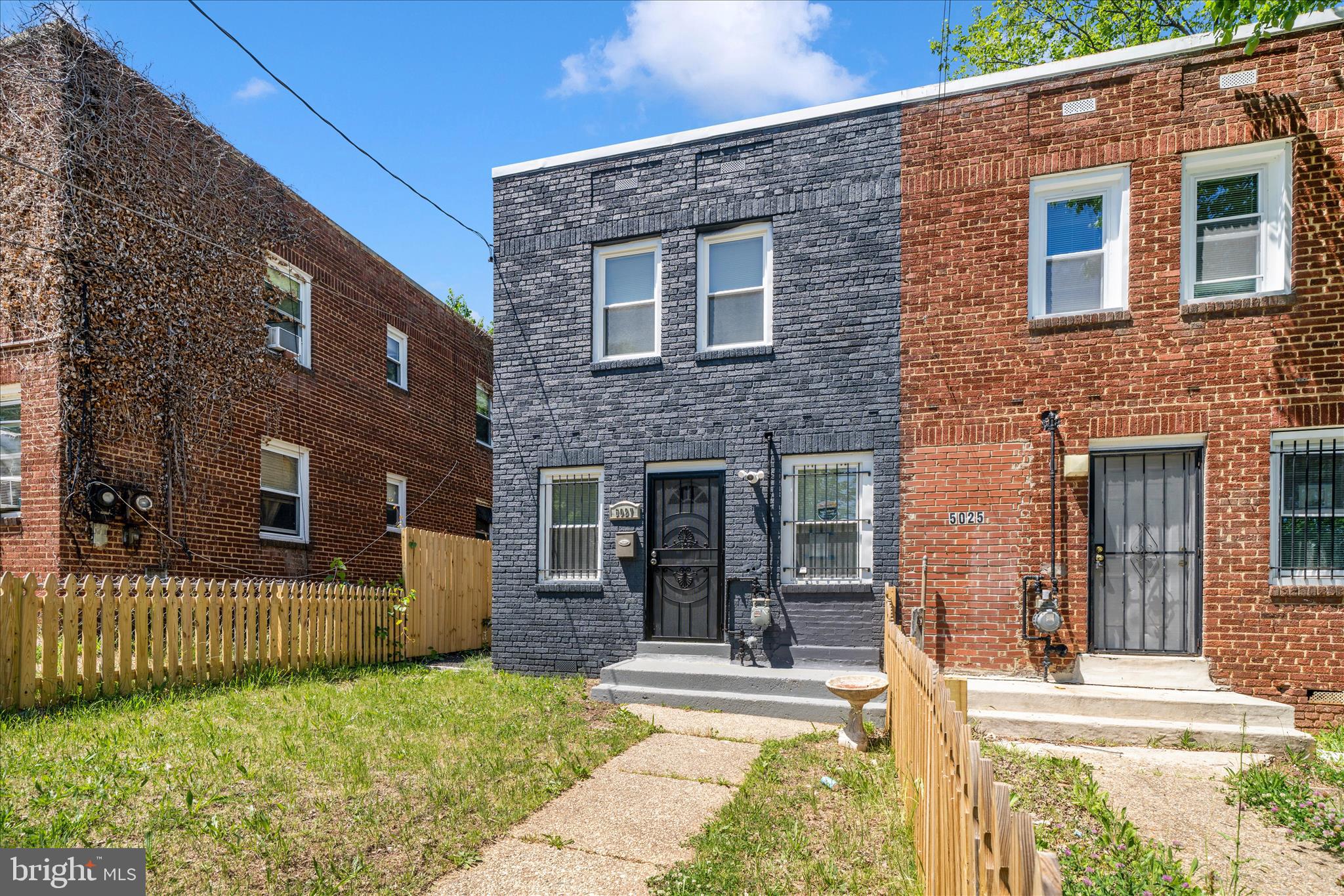 5027 Benning Road Southeast Washington, DC 20019 - Photo 3 of 57 a view of a house with a small yard and plants