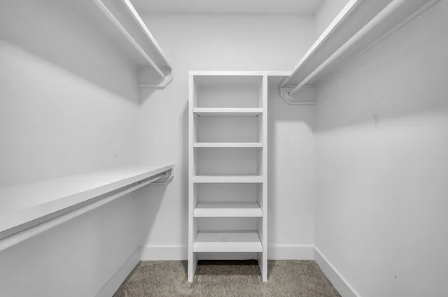 a bedroom with a bed and chandelier