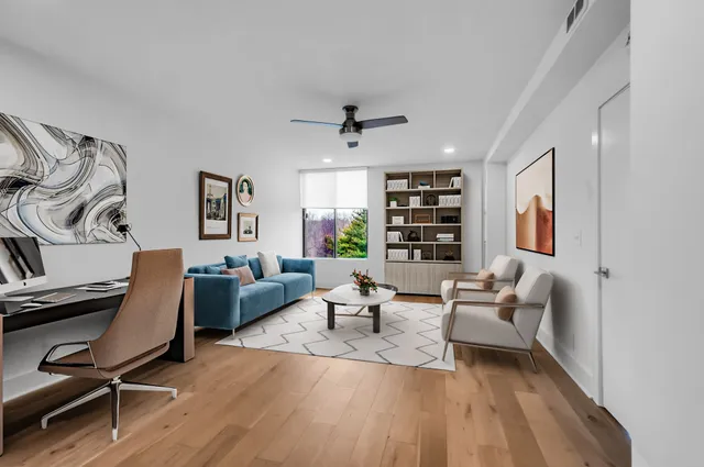 a living room with furniture a fireplace and a chandelier