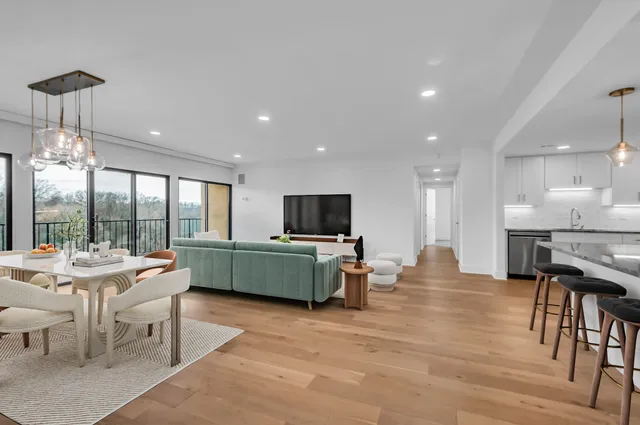 a room with furniture a flat screen tv and a large window