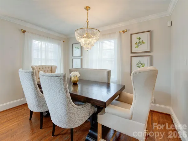 a view of a dining room with furniture wooden floor and a chandelier