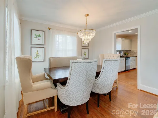 a view of a dining room with furniture wooden floor and chandelier