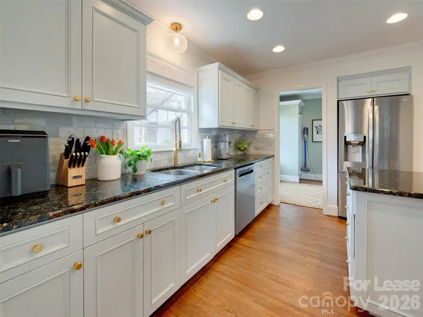 a large kitchen with stainless steel appliances lots of counter space sink and cabinets