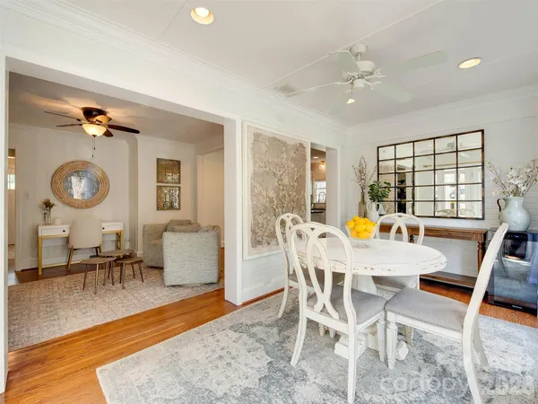 a view of a dining room with furniture and wooden floor