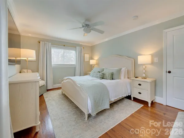 a spacious bedroom with a bed and a couch