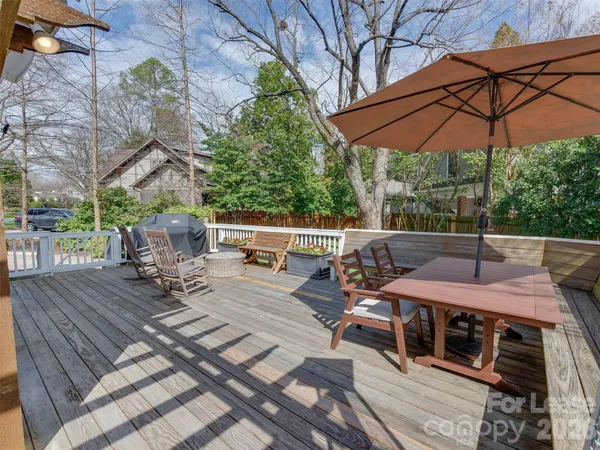 a view of a patio with furniture and umbrella