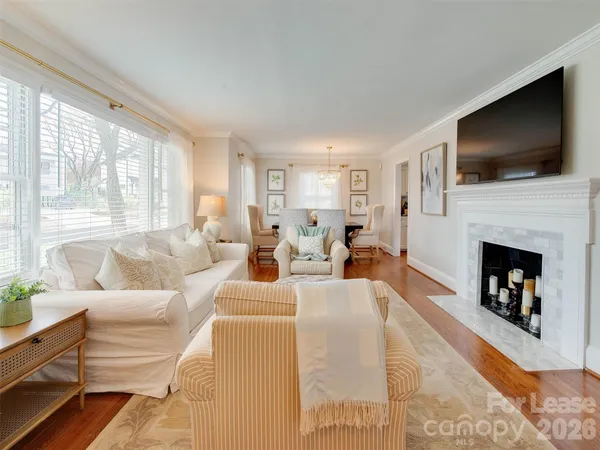 a living room with fireplace furniture and a flat screen tv