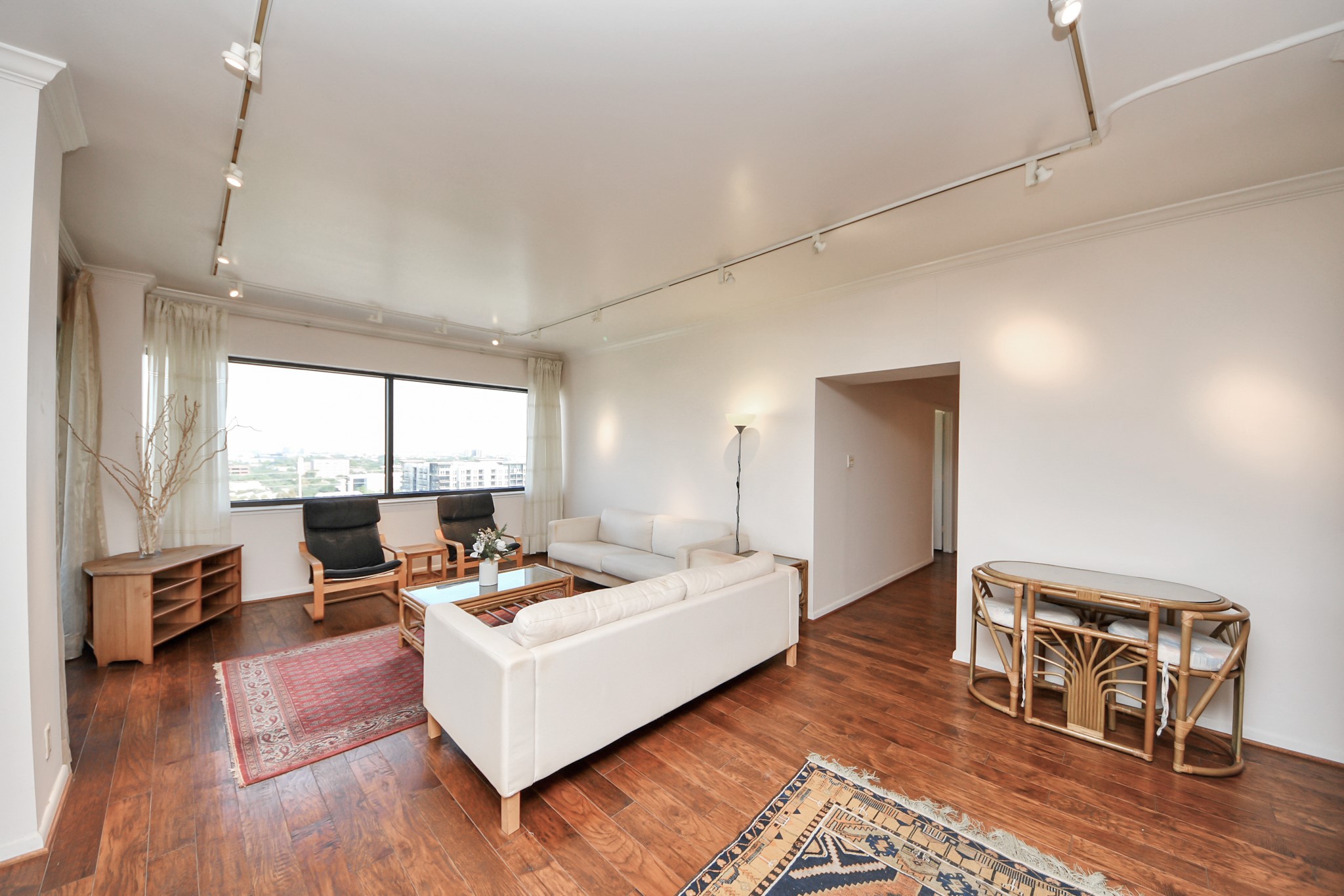 5000 Montrose Boulevard, Unit 14H Houston, TX 77006 - Photo 5 of 40 a living room with furniture and a wooden floor