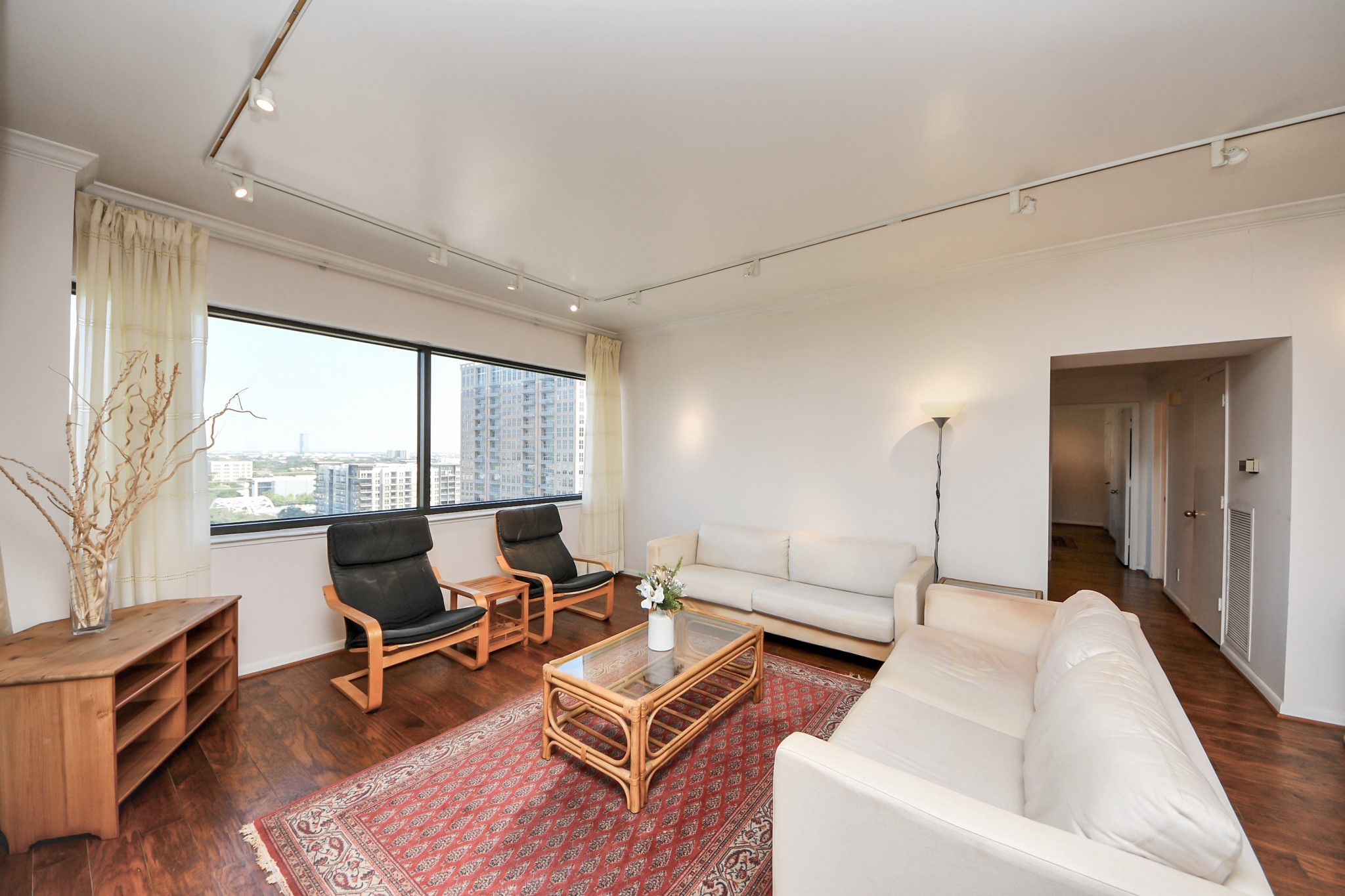 5000 Montrose Boulevard, Unit 14H Houston, TX 77006 - Photo 6 of 40 a living room with furniture and a large window