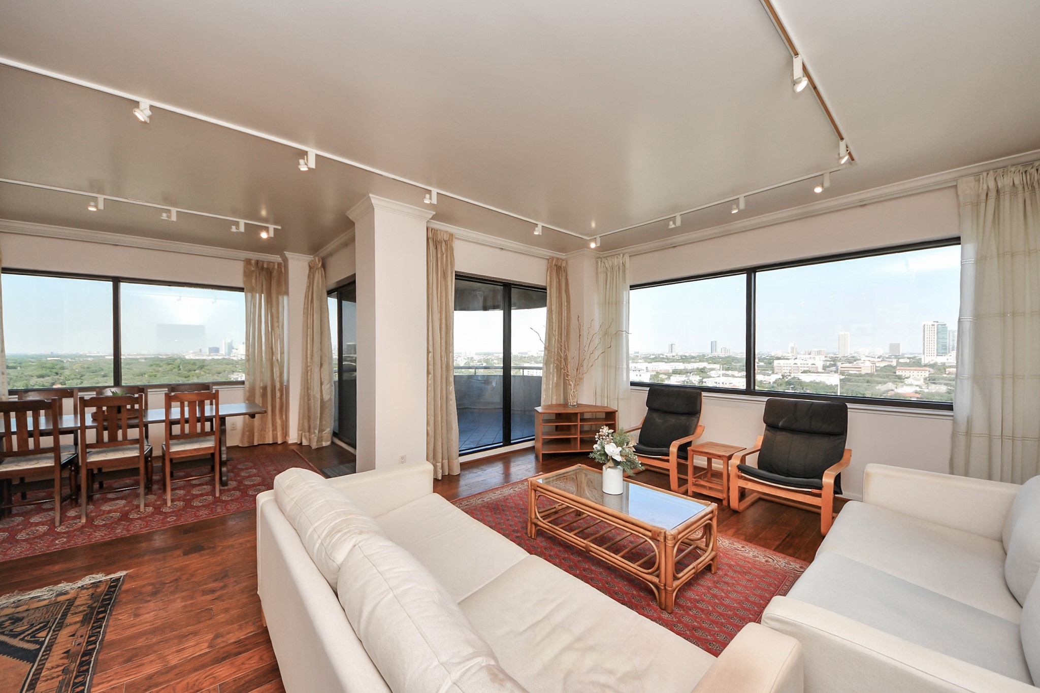 5000 Montrose Boulevard, Unit 14H Houston, TX 77006 - Photo 10 of 40 a living room with furniture and large windows
