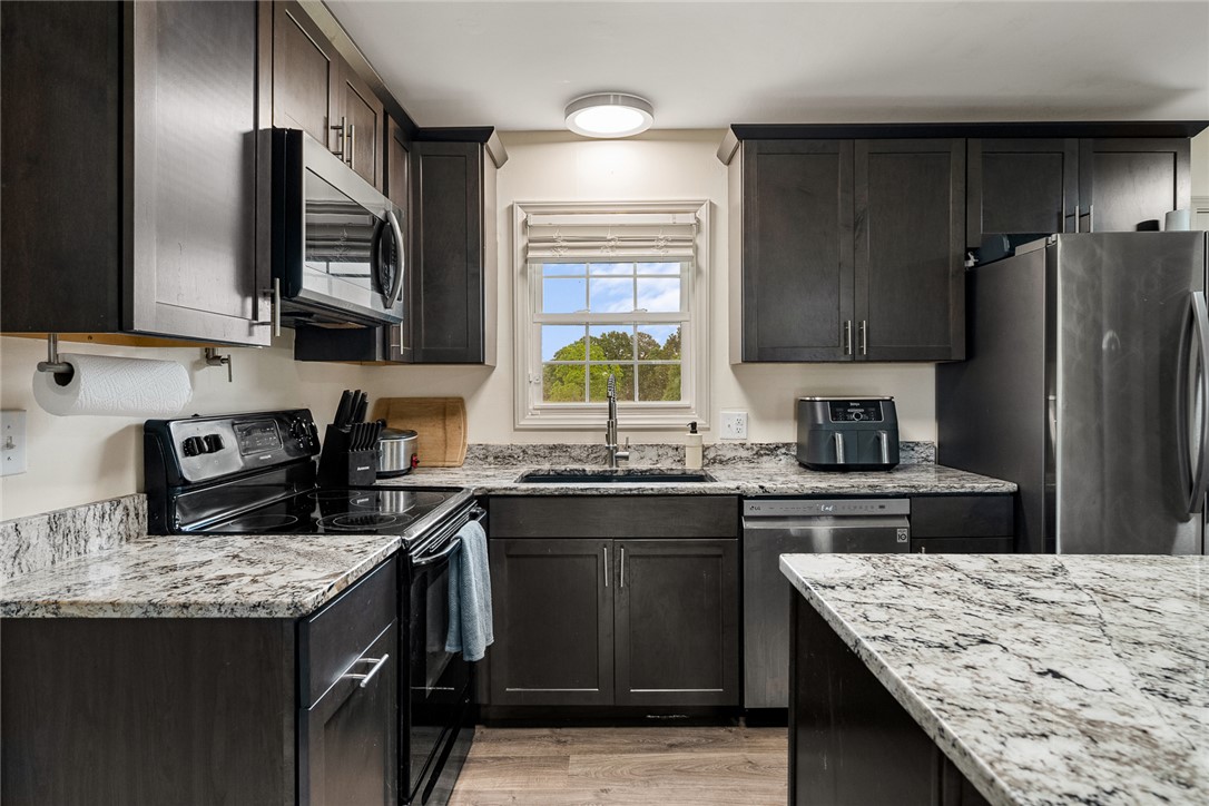 4508 Old Williamston Road Belton, SC 29627 - Photo 11 of 47 This contemporary kitchen features elegant countertops, modern cabinetry, and sleek appliances.