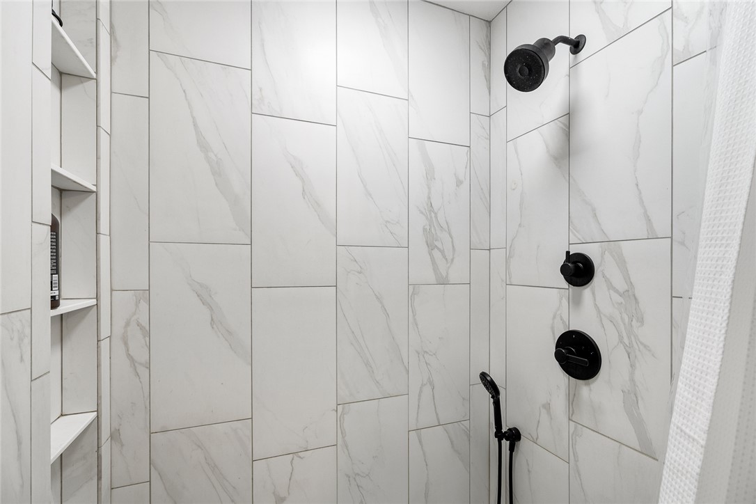 4508 Old Williamston Road Belton, SC 29627 - Photo 19 of 47 This modern bathroom features an upgraded shower with convenient built-in shelving.