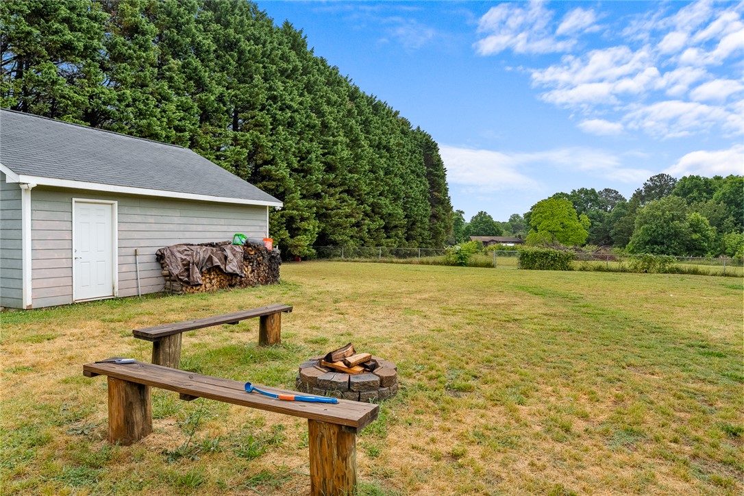 4508 Old Williamston Road Belton, SC 29627 - Photo 33 of 47 The spacious yard features a fire pit, storage shed, and ample space for outdoor enjoyment.