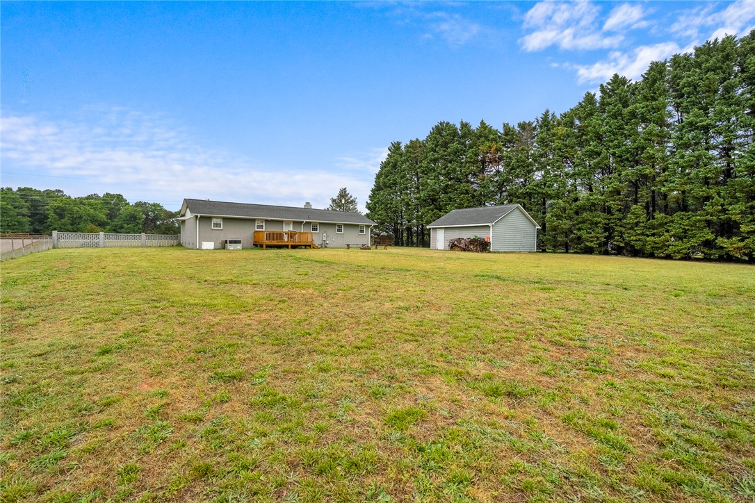 4508 Old Williamston Road Belton, SC 29627 - Photo 35 of 47 The enourmous backyard features a detached garage and a charming deck.