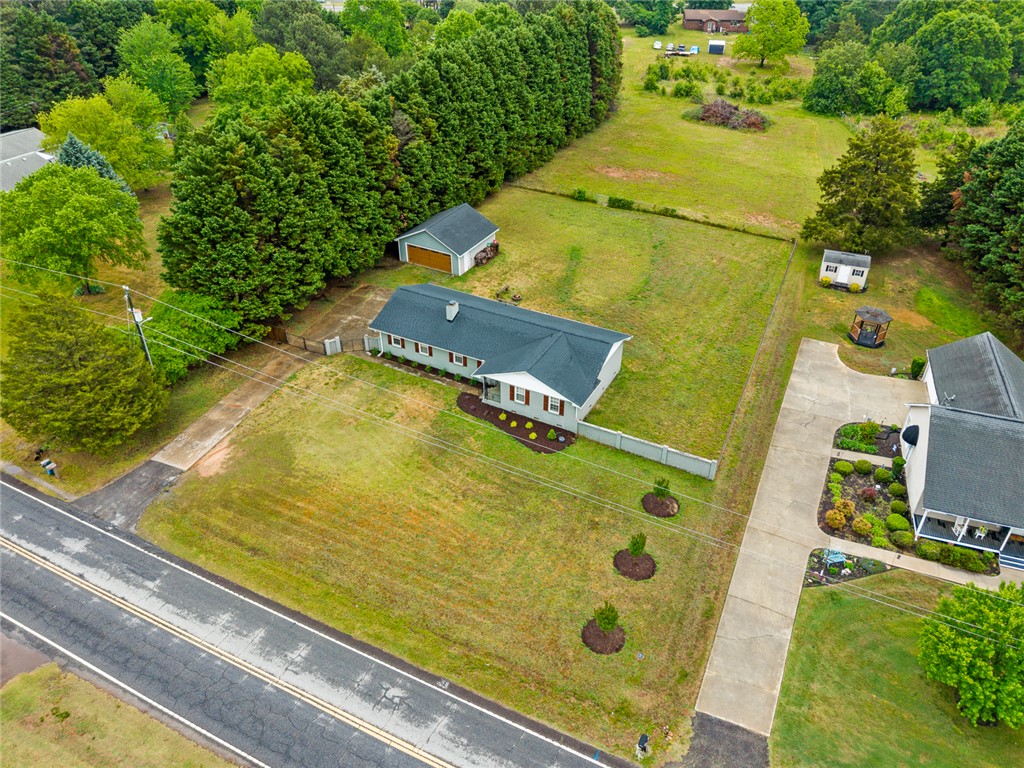 4508 Old Williamston Road Belton, SC 29627 - Photo 38 of 47 This expansive property offers a charming home, ample green space, and detached storage options.