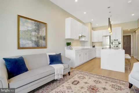 a living room with furniture and kitchen view