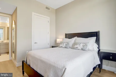 a bedroom with a bed and a night stand