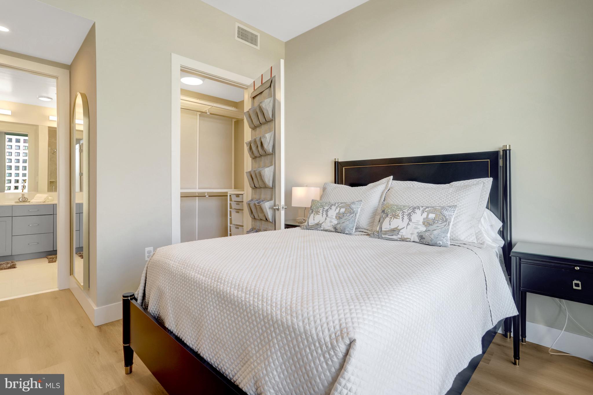 801 North Fairfax Street, Unit 314 Alexandria, VA 22314 - Photo 17 of 61 a bedroom with a bed and wooden floor