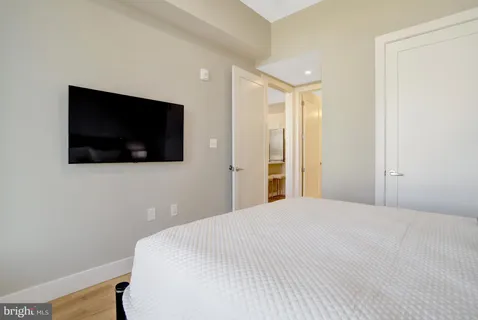 a bedroom with a bed and a flat screen tv