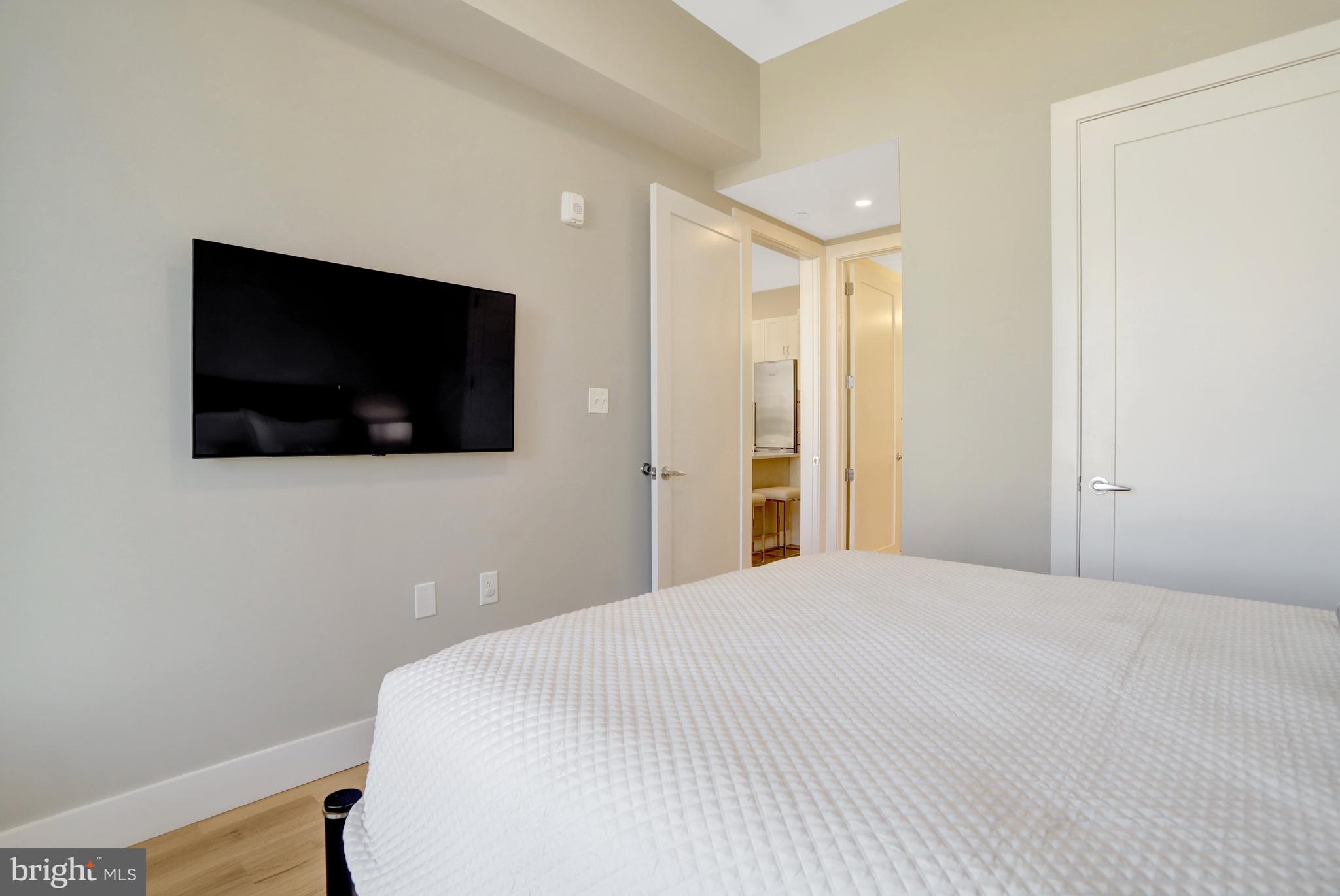 801 North Fairfax Street, Unit 314 Alexandria, VA 22314 - Photo 18 of 61 a bedroom with a bed and a flat screen tv