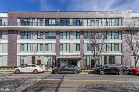 a view of building with parking area