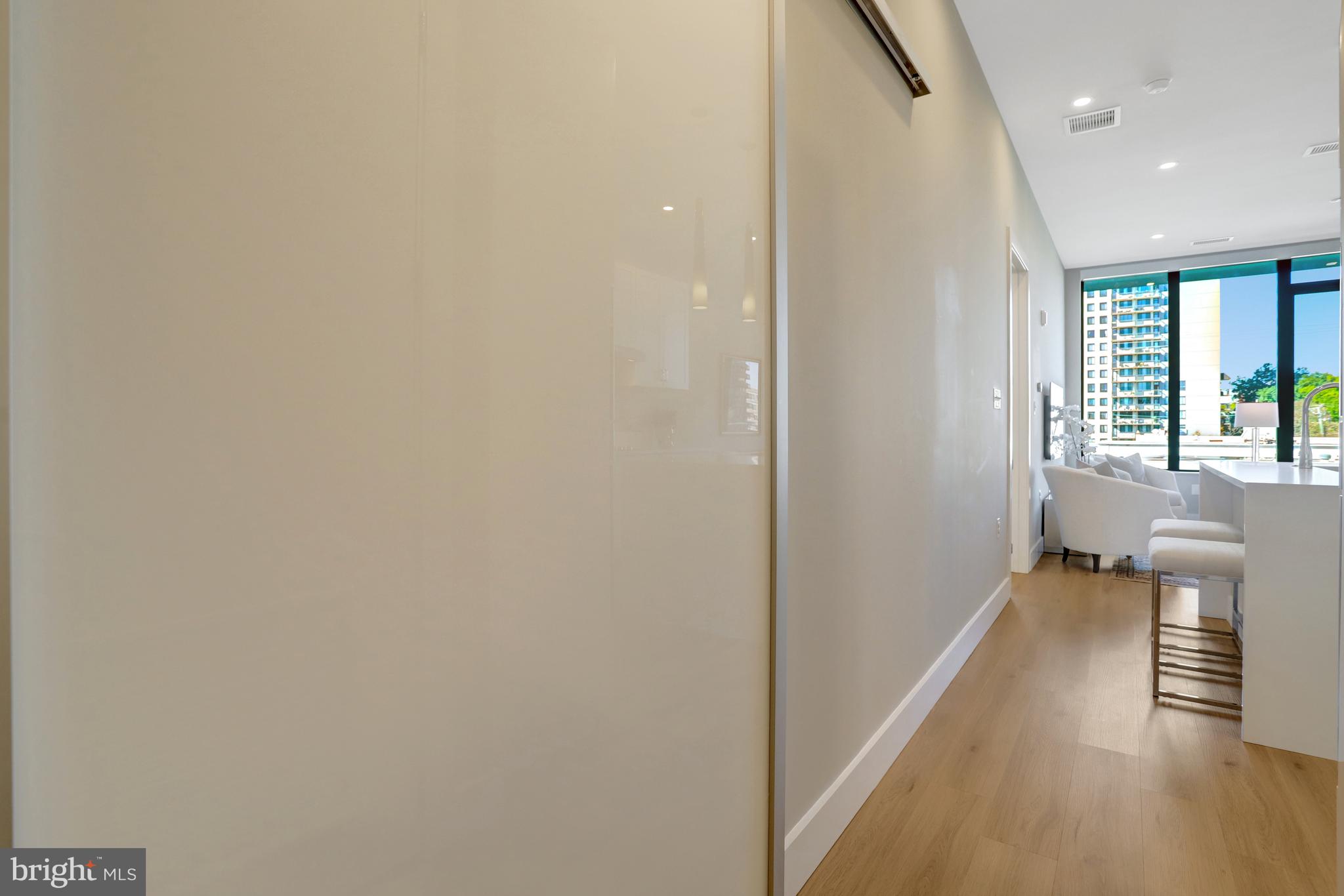 801 North Fairfax Street, Unit 314 Alexandria, VA 22314 - Photo 24 of 61 a view of a hallway with wooden floor and a bathroom