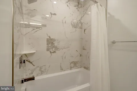 a bathroom with a bathtub and a shower