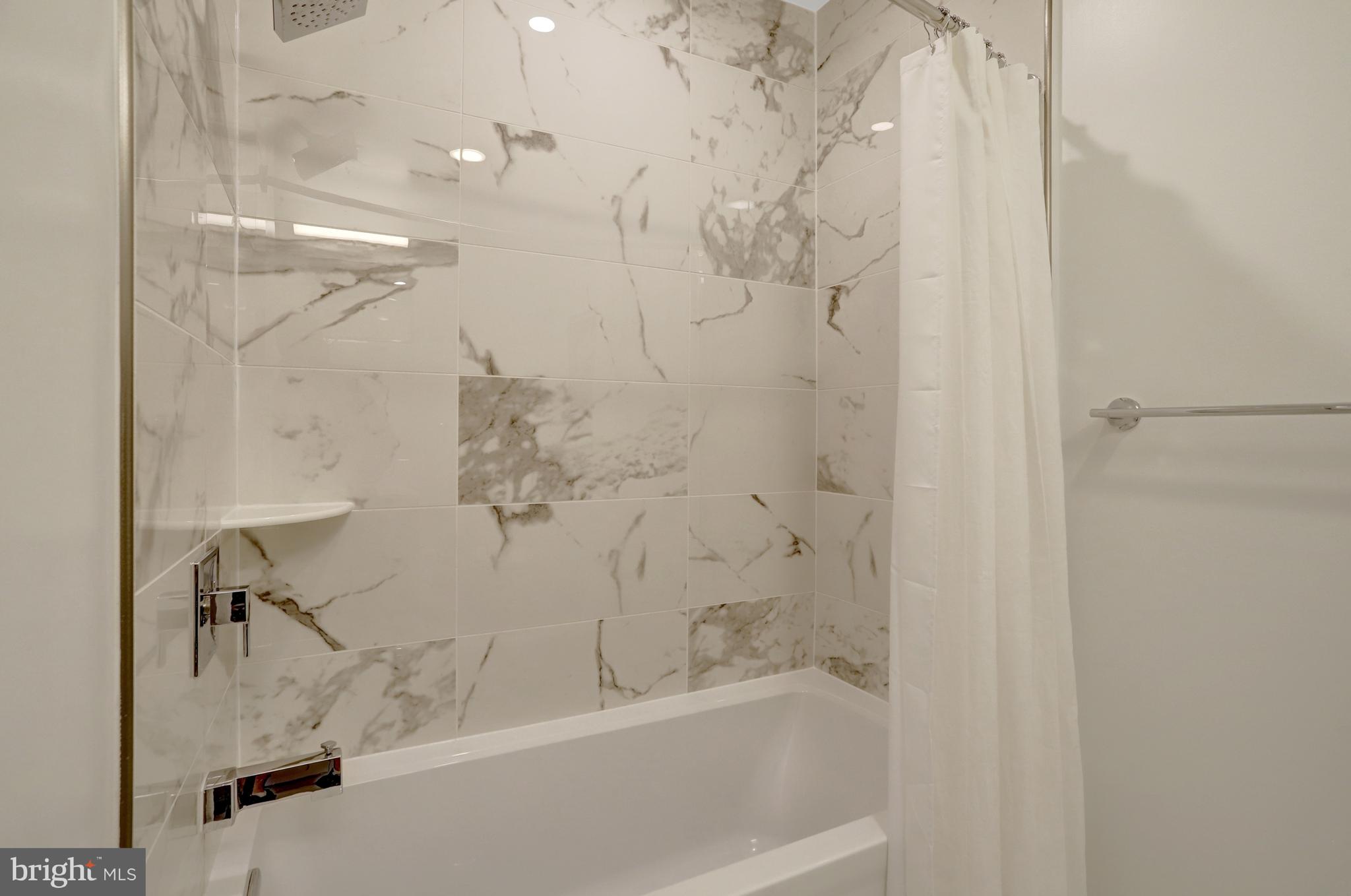 801 North Fairfax Street, Unit 314 Alexandria, VA 22314 - Photo 28 of 61 a bathroom with a bathtub and a shower