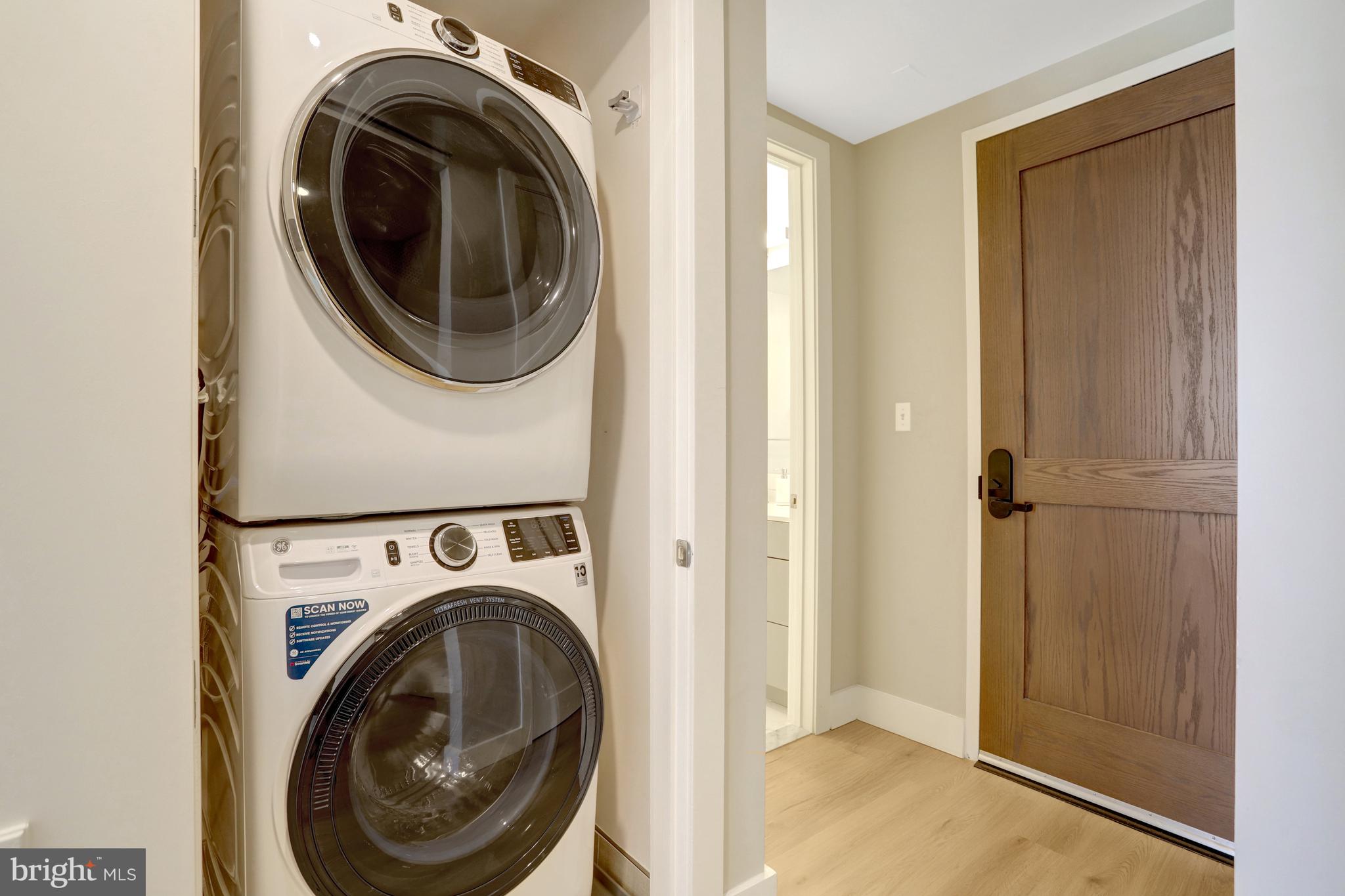 801 North Fairfax Street, Unit 314 Alexandria, VA 22314 - Photo 29 of 61 a view of a hallway with washer and dryer
