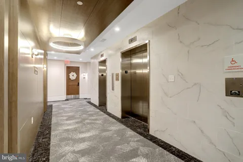 a view of a hallway with wooden cabinets