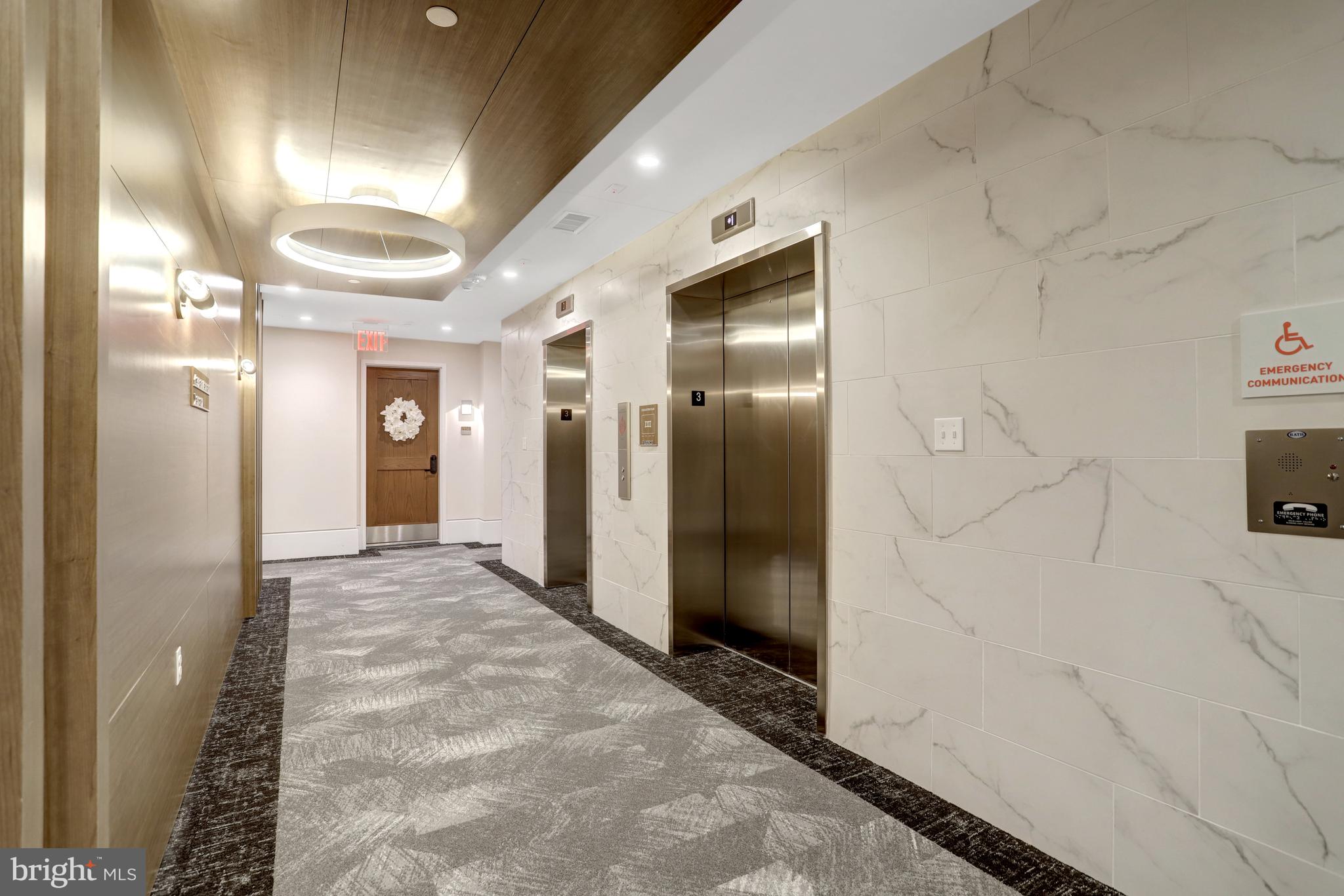 801 North Fairfax Street, Unit 314 Alexandria, VA 22314 - Photo 3 of 61 a view of a hallway with wooden cabinets