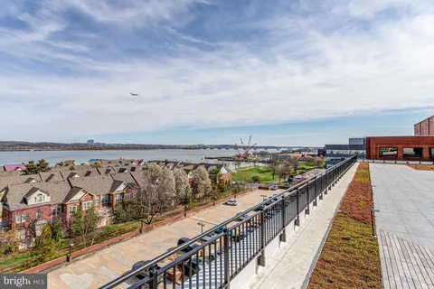 a front view of a house with a yard and potted plants