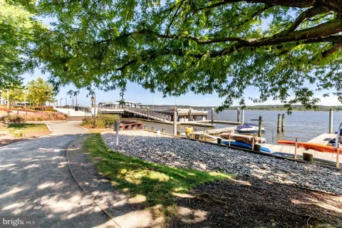 a view of a building with a cars park side of a street