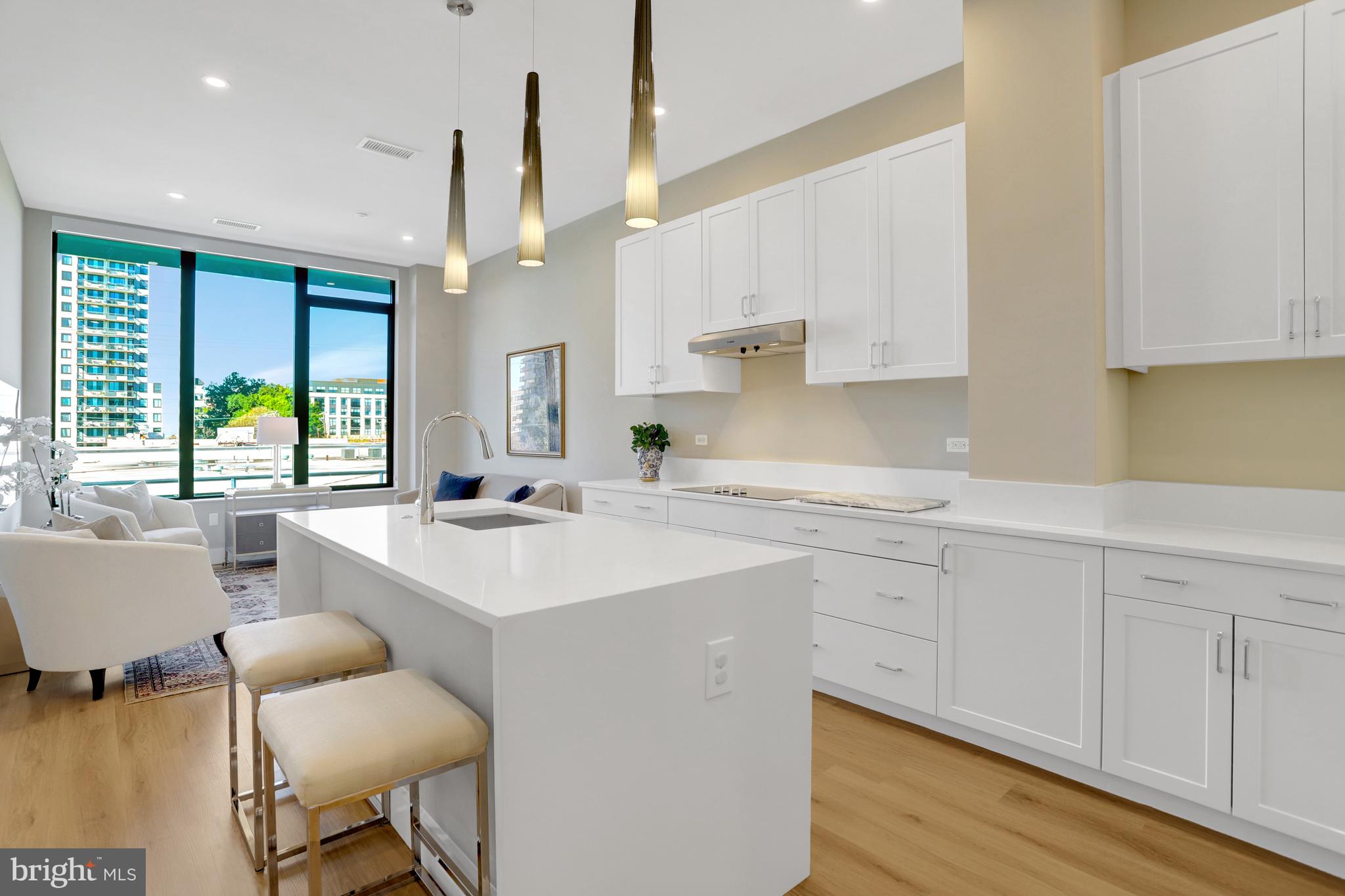 801 North Fairfax Street, Unit 314 Alexandria, VA 22314 - Photo 7 of 61 a kitchen with a sink chairs and cabinets