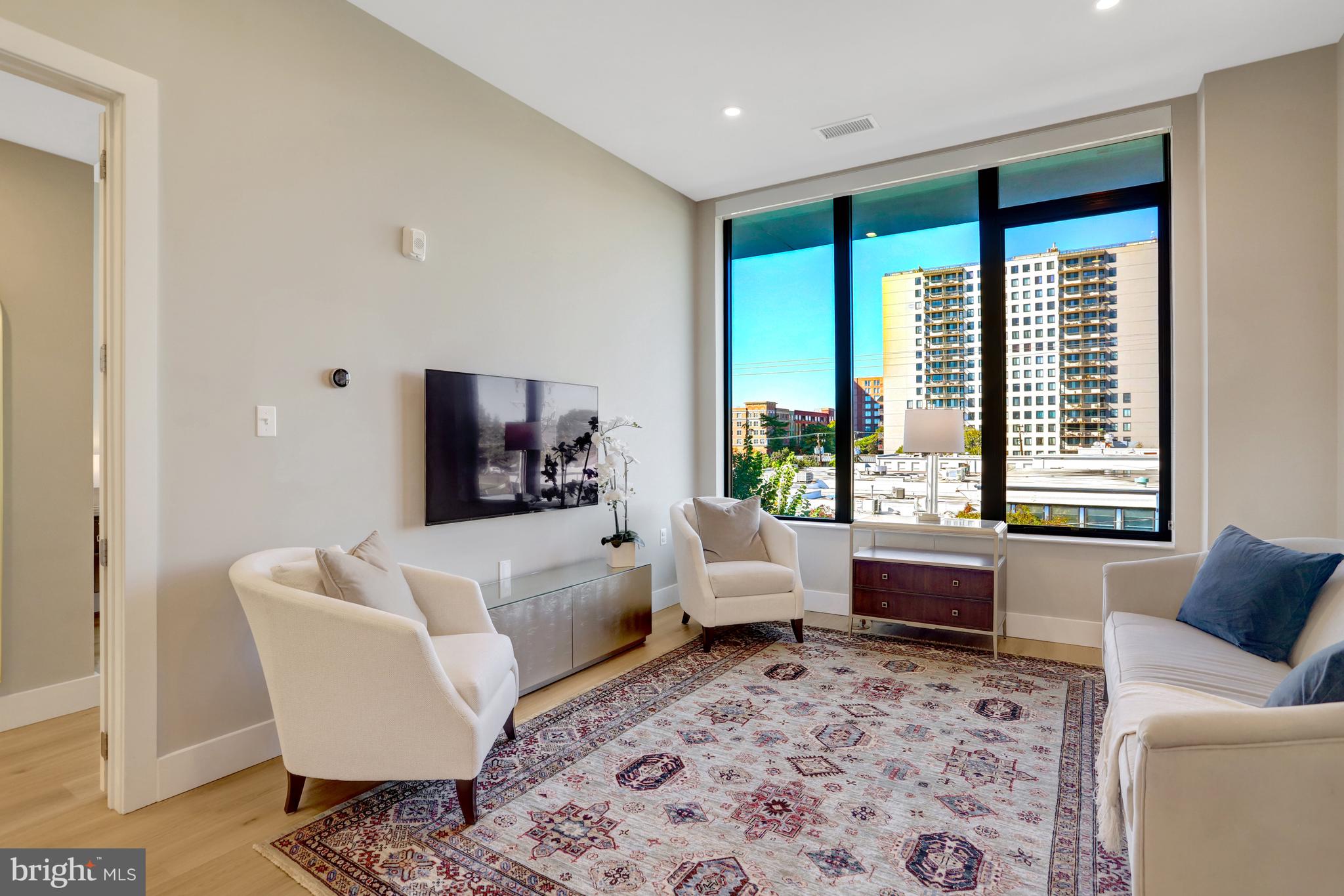 801 North Fairfax Street, Unit 314 Alexandria, VA 22314 - Photo 9 of 61 a living room with furniture and a large window