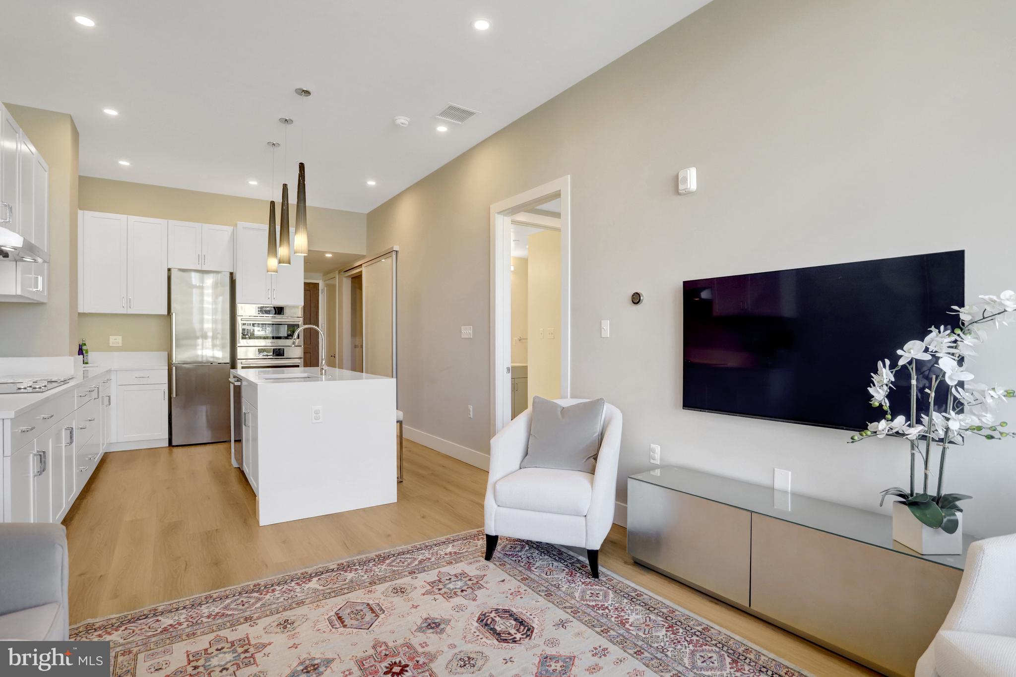 801 North Fairfax Street, Unit 314 Alexandria, VA 22314 - Photo 10 of 61 a living room with furniture and a flat screen tv