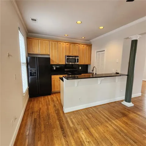 a view of a kitchen with wooden floor
