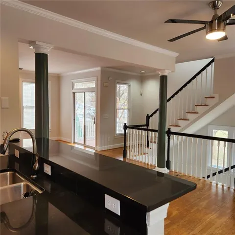a view of a hallway with wooden floor