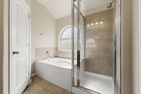 a bathroom with a bathtub and a shower