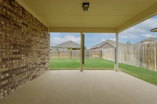 a view of a house with backyard and road