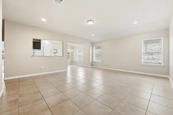 an empty room with windows and pillars in it