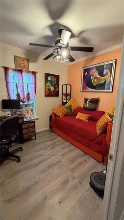 a bedroom with furniture and a ceiling fan