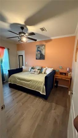 a bedroom with a bed next to a window