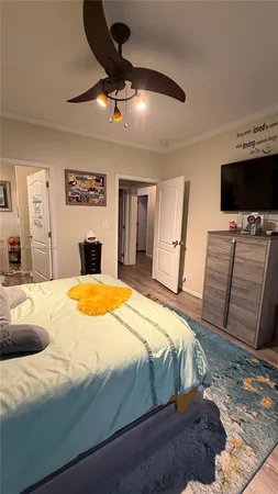 a bedroom with a bed and a flat screen tv