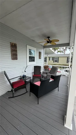 a living room with furniture a rug and white walls