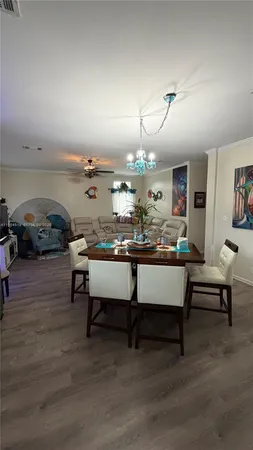 a room with table chairs and a wooden floor