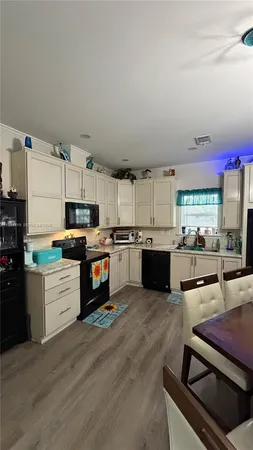 a kitchen with stainless steel appliances kitchen island granite countertop a stove and a sink