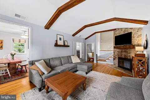 a living room with fireplace furniture and a flat screen tv