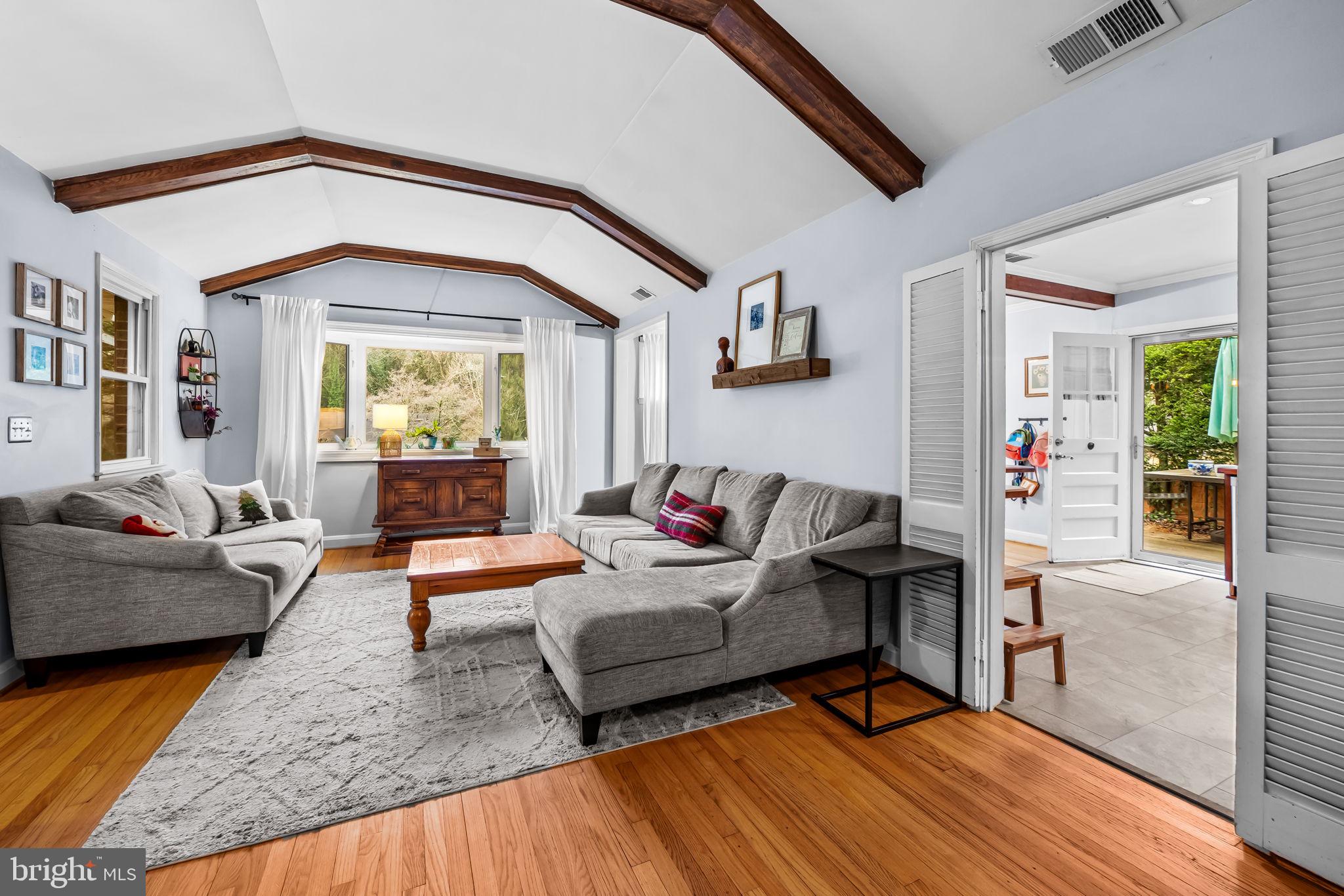 6745 Glenkirk Road Baltimore, MD 21239 - Photo 7 of 35 a living room with furniture and a large window